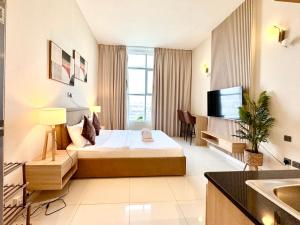 a hotel room with a bed and a tv at Signature Horizon Studio with Boulevard Views in Dubai
