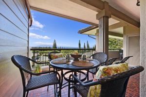 a patio with a table and chairs on a balcony at Kapalua Golf Villas 19T6 · KGV 19T6 Updated 2BD Kapalua Panorami in Kahana