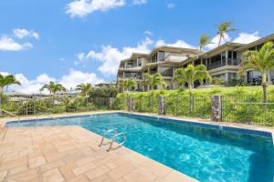 a swimming pool in front of a house at Kapalua Bay Villas 32B4 · KBV 32B4 Oceanfront Kapalua Spectacula in Kahana