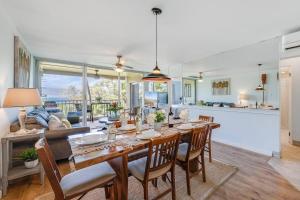 a dining room and living room with a table and chairs at Menehune Shores 403 · MHS 403 Remodeled BeachFront 2BD Getaway in Kihei