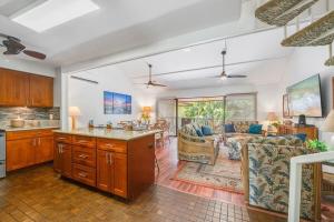 a kitchen and living room with a couch and a table at Koa Resort 3J · KOA 3J Remodeled 3BD w AC Pool Near Sandy Beach in Kihei