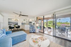 a living room with a blue couch and a table at Wailea Ekahi 21A · WEK 21A Remodeled Wailea Condo Pool AC Near B in Wailea