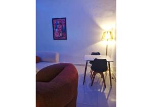 sala de estar con sofá, mesa y lámpara en Zeeshortlet Apartment, en Lekki 2 fotos más