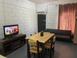 a living room with a table and a couch at Sin Permiso Hospedaje in San Fernando del Valle de Catamarca