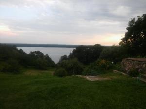 a view of a body of water from a field at Pod Zachrypniętym Kogutem in Glewo