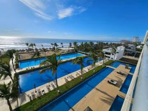 an aerial view of a pool with the beach at Beachfront Apartment in Mazatlán