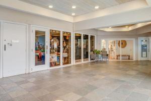 a large room with a tile floor and glass doors at Kahana Villa F405 · KV F405 Perfect Maui Getaway Condo w Ocean V in Kahana +43 photos
