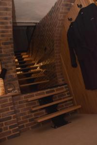 a brick staircase with a tv on a brick wall at La Luxure- Loveroom in Maucomble +4 photos