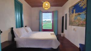 Un pat sau paturi într-o cameră la Hostal Rancho Ventura +4 fotografii