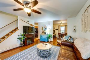 a living room with a couch and a ceiling fan at Walk to Owasco Lake Auburn Home with Hot Tub in Auburn