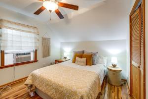 a bedroom with a bed and a ceiling fan at Walk to Owasco Lake Auburn Home with Hot Tub in Auburn