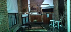 a patio with a table and two stools at Casa Hogar-Barbacoa y Garaje in Salto +1 photo