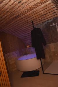 a bath tub in a room with a ceiling at La Luxure- Loveroom in Maucomble