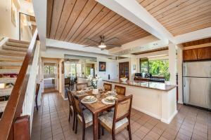 a dining room with a table and a kitchen at Kahana Village 2 · KHV 2 Direct Oceanfront 2BD Condo Steps to Be in Kahana