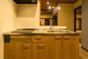 a kitchen with a sink and a mirror at 滋庵 jian okayama in Okayama +15 photos