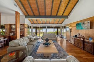 a living room with a couch and a table at Hale Kalapu · Large Home 180° Ocean Views Walk2Beach Hale Kalapu in Kaanapali