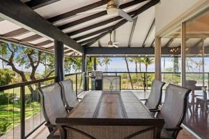 an outdoor dining room with a table and chairs at Hale Kalapu · Large Home 180° Ocean Views Walk2Beach Hale Kalapu in Kaanapali