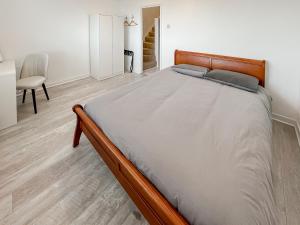 a large bed in a bedroom with a desk and a chair at Oasis in Hythe