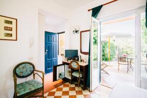 a living room with a door open to a patio at Villino Eleonora in Parghelia