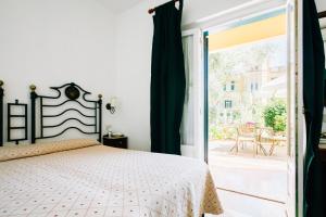 a bedroom with a bed next to a sliding glass door at Villino Eleonora in Parghelia