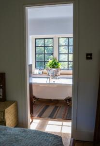 a bathroom with a bath tub and a window at The little Hotel in Motcombe
