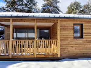 a log cabin with a deck in the snow at Chalet confortable 4 pers, vue montagne, terrasse - FR-1-840-55 in Aussois