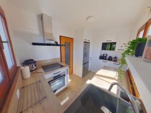 a kitchen with a sink and a counter top at Chalet au calme pour 10 pers, proche centre et activités - FR-1-834-9 in Les Rousses
