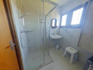 a white bathroom with a shower and a sink at Chalet au calme pour 10 pers, proche centre et activités - FR-1-834-9 in Les Rousses +11 photos