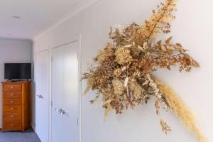 a wreath is hanging on a wall at Rainbow Haven Where family time meets Lake time in Coffs Harbour