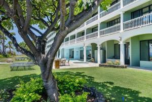 a building with a tree in front of it at Lahaina Shores 215 · LS 215 Direct Beachfront Views Remodeled St in Lahaina