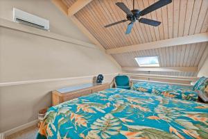 a bedroom with a bed and a ceiling fan at Kahana Village 9 · KHV 9 2BR Oceanfront Condo w Panoramic Maui in Kahana +21 photos