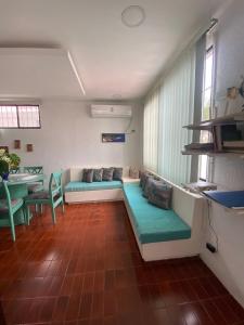 a living room with a couch and a table at Jardines del mar in Santa Elena