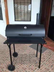 a black piano sitting on top of a brick floor at Jardines del mar in Santa Elena +26 photos