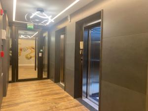a hallway with multiple elevators in a building at LOFTS Vila Germânica in Blumenau