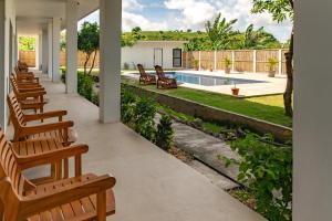 a patio with chairs and a swimming pool at Satu Hati Hotel in Ekas