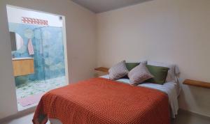 a bedroom with a bed and a glass shower at Spacious apartment in Buga, super central in Buga