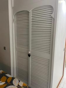a room with a closet with a window with blinds at Ti-CHERRY in Le Diamant +34 photos