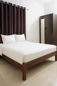a bed in a bedroom with a black headboard at Dhaka Furnished Apartment in Gulshan in Dhaka