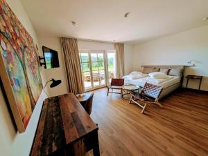 a living room with a couch and a table at Landhotel Hofgut Battenberg in Battenberg