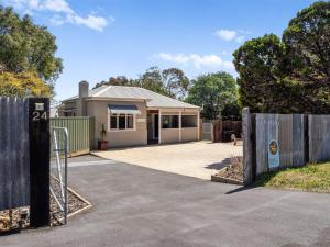 a house with a gate in front of a driveway at Whitehouse Cottage - Margaret River in Margaret River Town