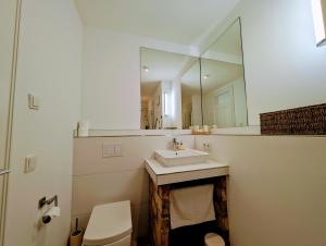 a bathroom with a sink and a mirror at Landhotel Hofgut Battenberg in Battenberg +41 photos