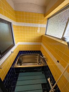 a yellow and blue tiled bathroom with a sink at Nagahama - House - Vacation STAY 18509 in Nagahama