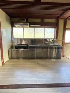 a large kitchen with stainless steel appliances in a room at Nagahama - House - Vacation STAY 18509 in Nagahama