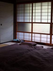 a bedroom with a bed and a large window at Nagahama - House - Vacation STAY 18509 in Nagahama +5 photos