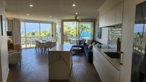 a kitchen and living room with a view of the ocean at Whalewatch Ocean Beach Resort in Point Lookout