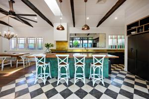an open kitchen with a checkered floor at Luxury Family Estate l Pet Friendly l Nova Escapes in Bangalow +96 photos