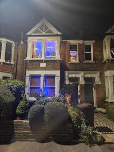 a house with blue lights in the windows at The blue international inn in London