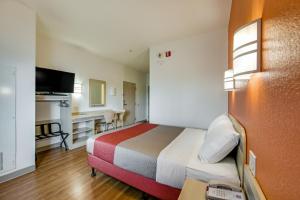 ブランプトンにあるMotel 6-Brampton, ON - Torontoのベッドとデスクが備わるホテルルームです。