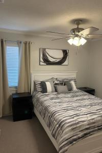 リチャードソンにあるFamily Comfort Retreat & Spacious Yardの天井ファン付きの大きなベッドのある寝室
