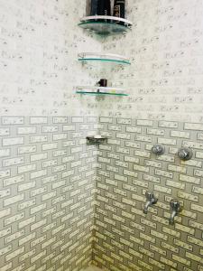 a white brick wall with two shelves on it at Bashundhara Luxury 3BR Apartment Near Evercare in Dhaka